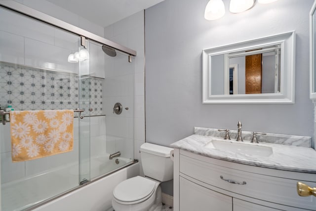 full bathroom with shower / bath combination with glass door, vanity, and toilet