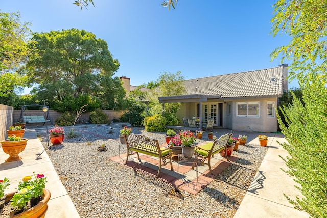 rear view of house featuring french doors, a patio, and an outdoor hangout area