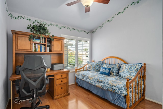 bedroom featuring ceiling fan, lofted ceiling, and light hardwood / wood-style flooring