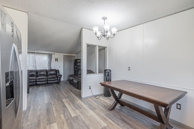 15035 E E Ave Unit G, Lancaster, CA 93535 - dining space with a chandelier, a textured ceiling, light wood-style flooring, and vaulted ceiling