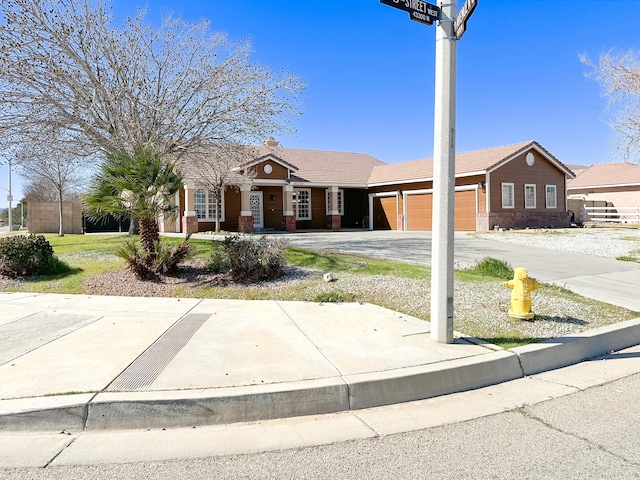 ranch-style home with a garage and driveway