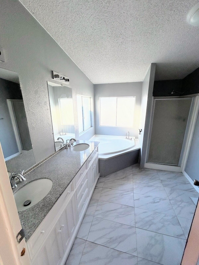 bathroom featuring vanity, a textured ceiling, and independent shower and bath