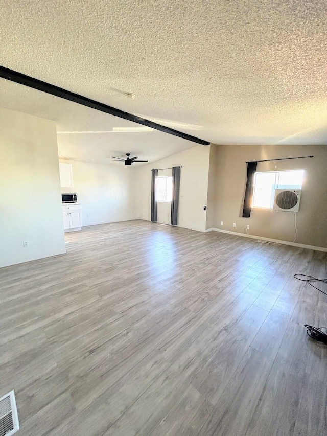 spare room with ceiling fan, a textured ceiling, and light hardwood / wood-style flooring