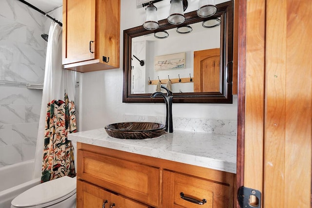 full bathroom with shower / tub combo, vanity, and toilet