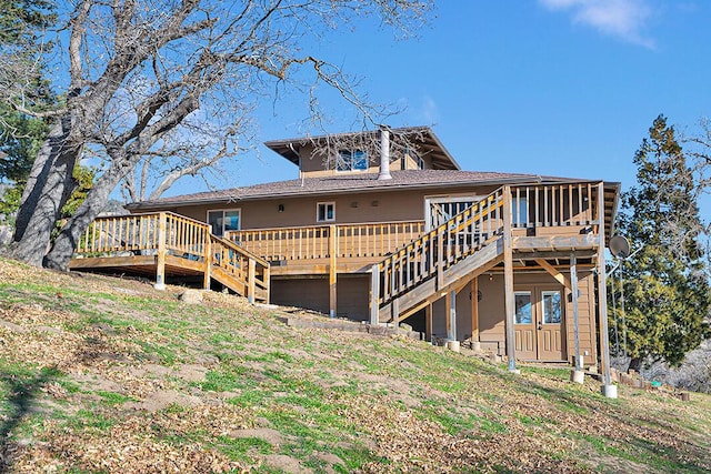 rear view of property featuring a wooden deck