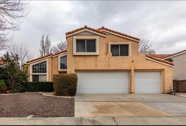 view of front of home featuring stucco siding, driveway, and a tiled roof