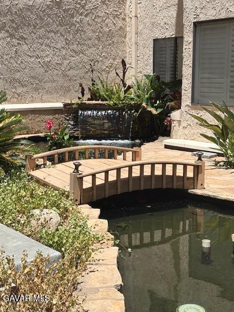 5310 Zelzah Ave Unit 305, Encino, CA 91316 - exterior view of a small pond and stucco siding