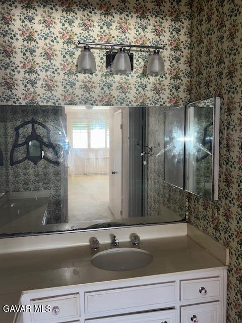 5310 Zelzah Ave Unit 305, Encino, CA 91316 - bathroom with wallpapered walls and vanity