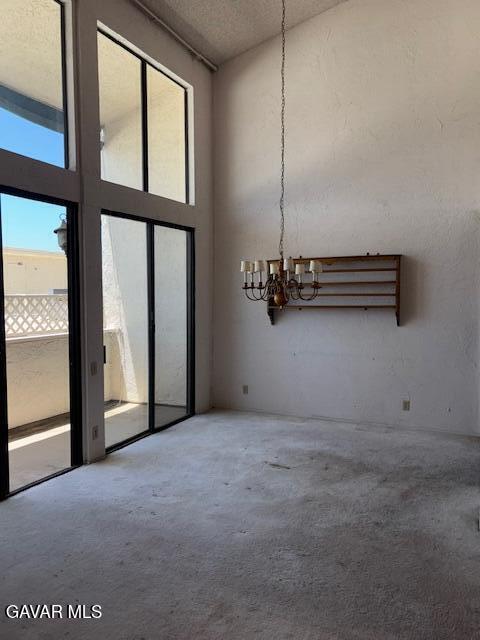 5310 Zelzah Ave Unit 305, Encino, CA 91316 - carpeted spare room featuring a chandelier and a towering ceiling