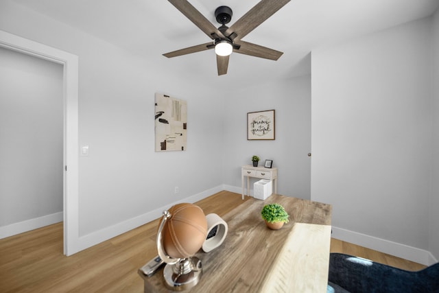 dining space with hardwood / wood-style flooring and ceiling fan