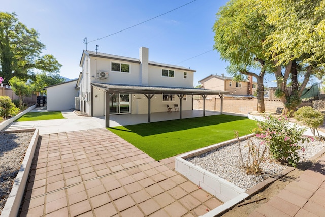 back of property featuring a yard and a patio