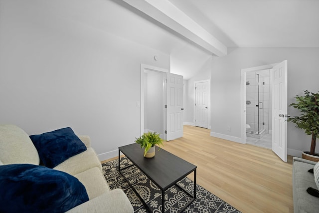 living room featuring vaulted ceiling with beams and wood-type flooring