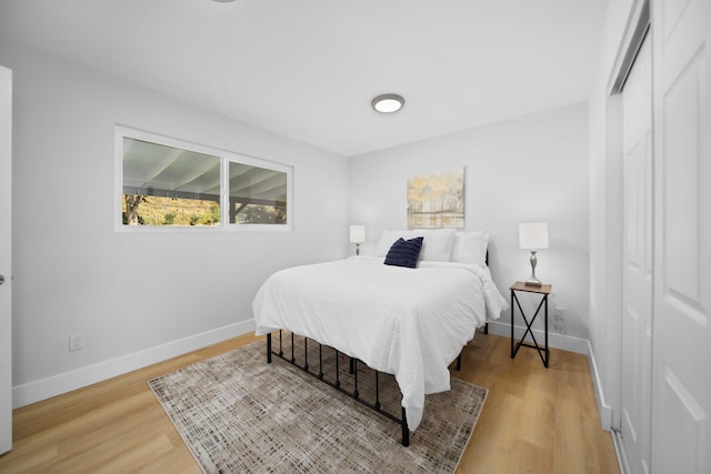 bedroom with a closet and light hardwood / wood-style flooring