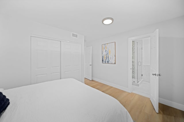 bedroom with a closet and hardwood / wood-style floors