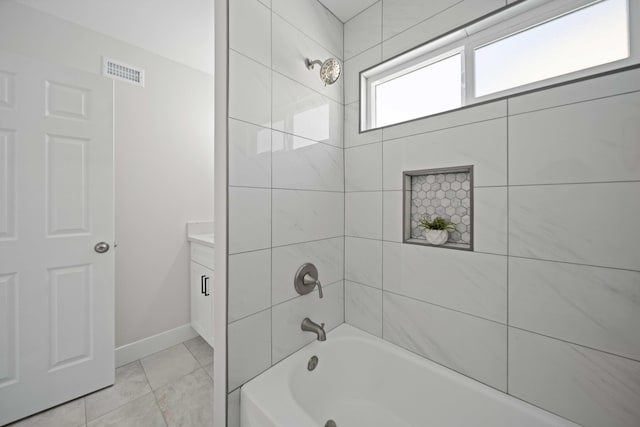 bathroom featuring vanity and tiled shower / bath combo