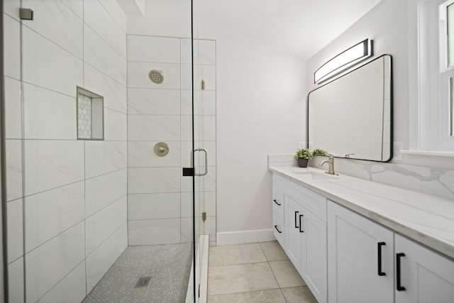 bathroom with tile patterned floors, vanity, and walk in shower