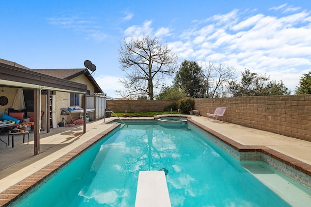 view of pool featuring a diving board, a patio, a fenced backyard, and a pool with connected hot tub