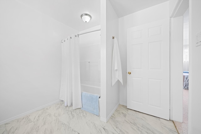 full bathroom with baseboards, marble finish flooring, and shower / bath combo