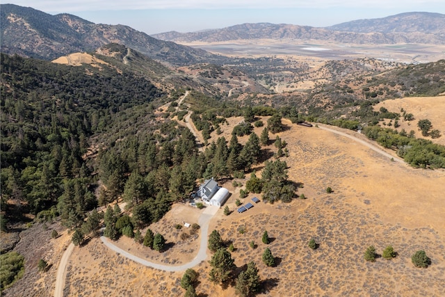 aerial view of property and surrounding area featuring a mountainous background