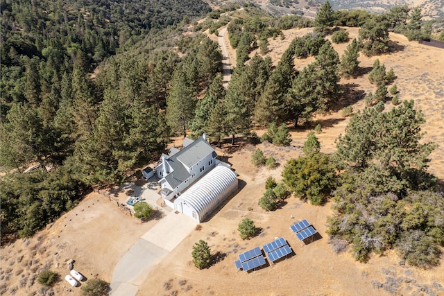 view from above of property featuring a heavily wooded area