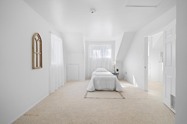 unfurnished bedroom featuring carpet flooring, baseboards, and attic access