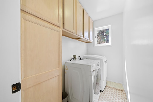 washroom with washer and dryer and cabinet space