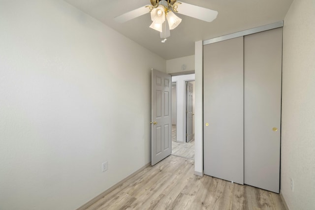 unfurnished bedroom featuring a closet, light wood-style flooring, and ceiling fan