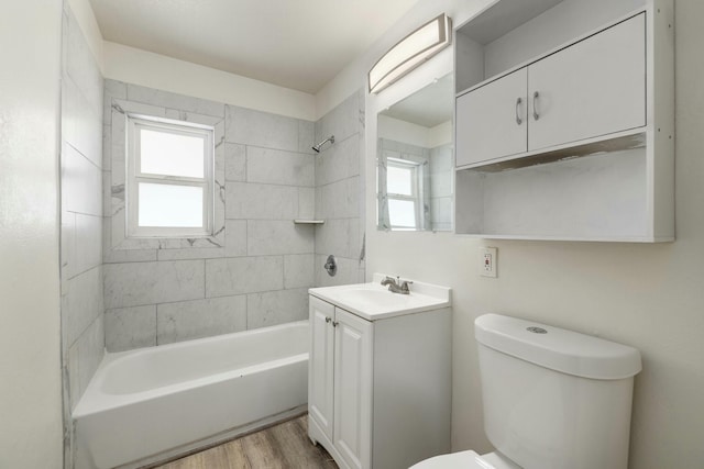 full bathroom featuring a healthy amount of sunlight, toilet, vanity, and wood finished floors