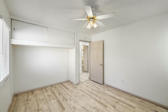 unfurnished bedroom featuring a closet, wood finished floors, and a ceiling fan