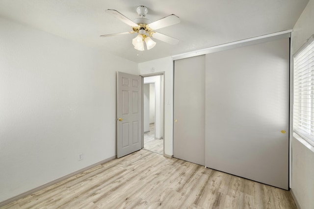 unfurnished bedroom with light wood-style floors, a closet, and ceiling fan