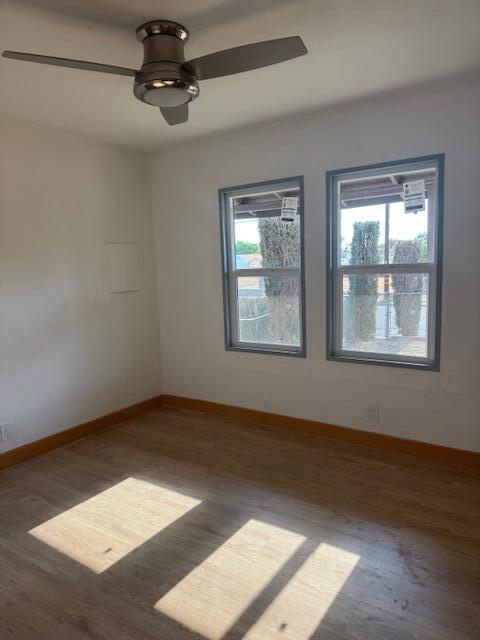 43427 Fairglen Rd, Lancaster, CA 93535 - unfurnished room featuring wood finished floors, baseboards, and a ceiling fan