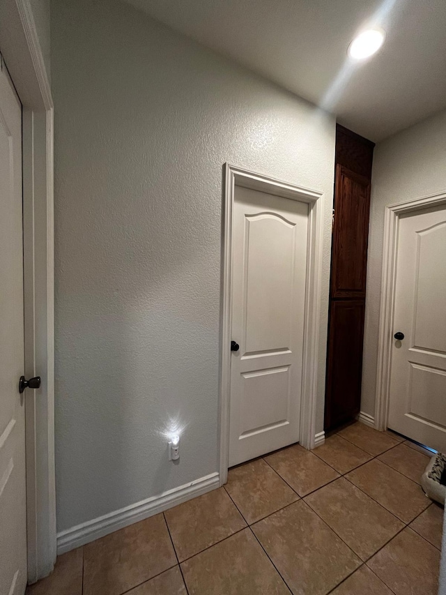 hallway with light tile patterned floors