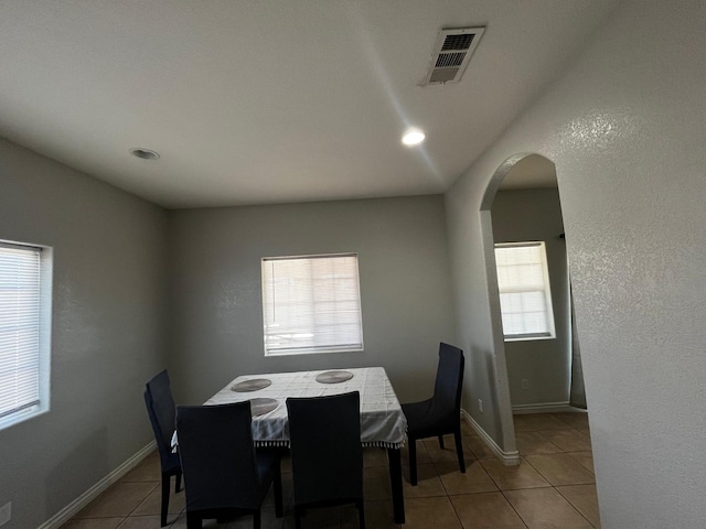 dining space with light tile patterned flooring and a healthy amount of sunlight