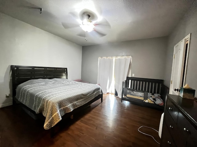 bedroom featuring ceiling fan and dark hardwood / wood-style flooring