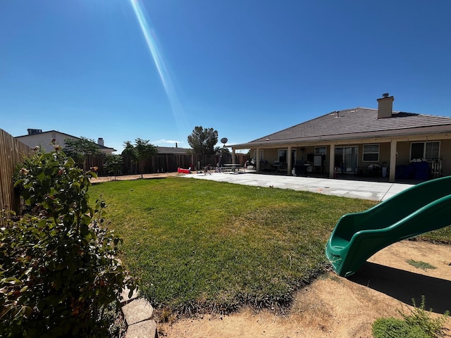 view of yard featuring a patio and a playground