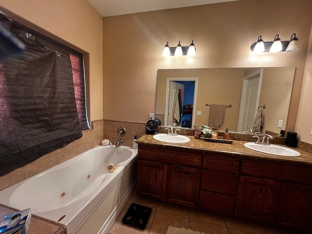 bathroom with tile patterned floors, vanity, and a tub to relax in