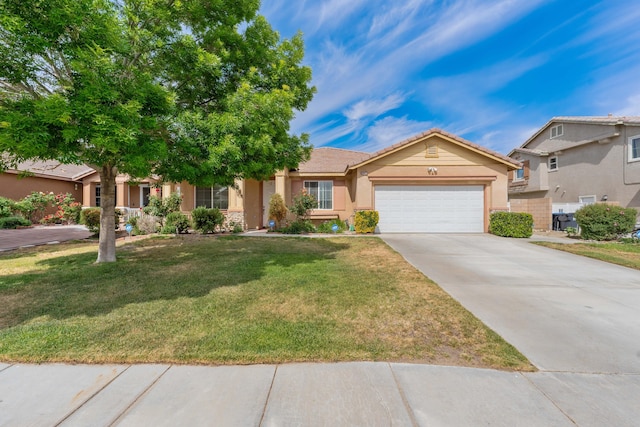 view of front of property with a front yard, stucco siding, an attached garage, driveway, and a tile roof
