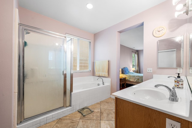 full bathroom featuring a sink, double vanity, tile patterned floors, a shower stall, and a bath
