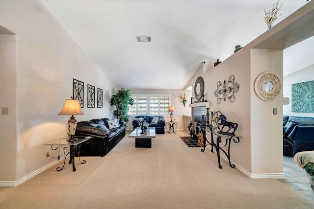 living room featuring a tile fireplace, carpet, and lofted ceiling