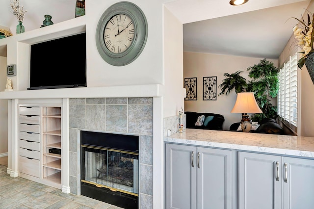 living room with a fireplace and lofted ceiling