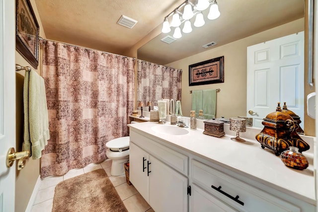 bathroom with tile patterned floors, vanity, and toilet