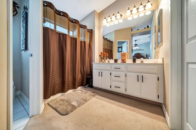 bathroom featuring ceiling fan, vanity, and walk in shower