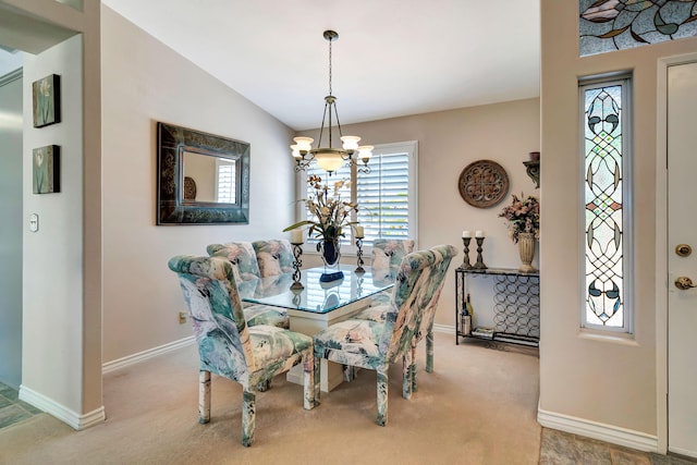 dining area featuring carpet floors, vaulted ceiling, and a notable chandelier