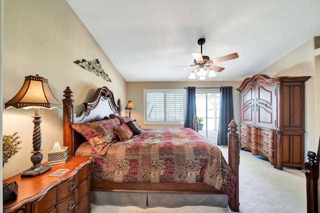 carpeted bedroom with access to outside, ceiling fan, and vaulted ceiling