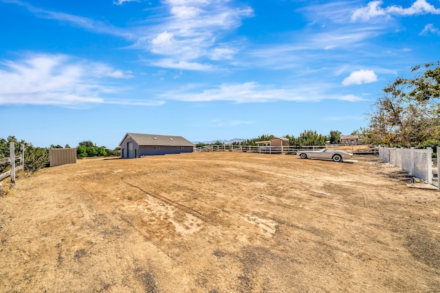 view of yard with a rural view