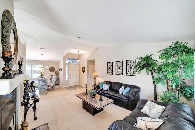 living room featuring vaulted ceiling, light carpet, and an inviting chandelier