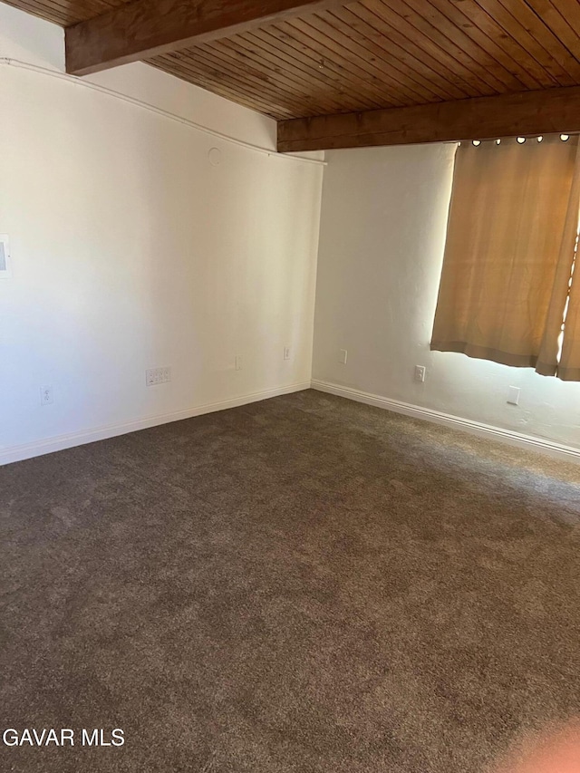 3358 Martin Ave, Mojave, CA 93501 - empty room with dark carpet and a wooden ceiling with exposed beams