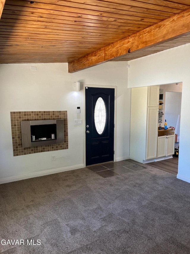 3358 Martin Ave, Mojave, CA 93501 - entrance foyer with a wood ceiling with exposed beams, dark carpet, and a tile fireplace