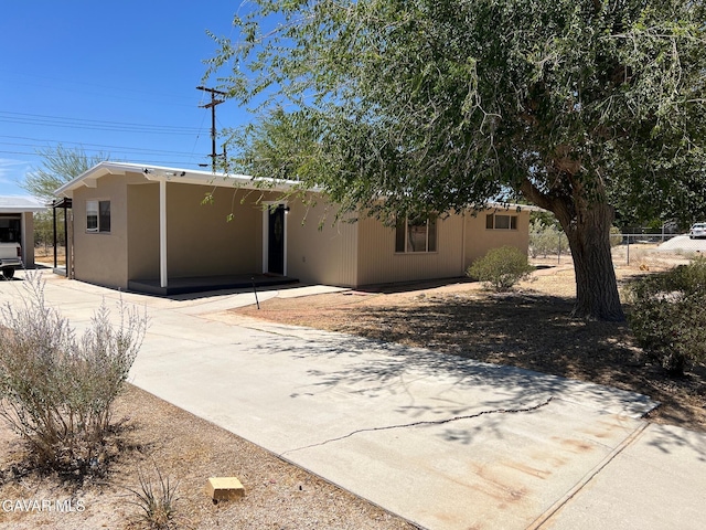 3358 Martin Ave, Mojave, CA 93501 - view of front of property featuring stucco siding, driveway, and a carport