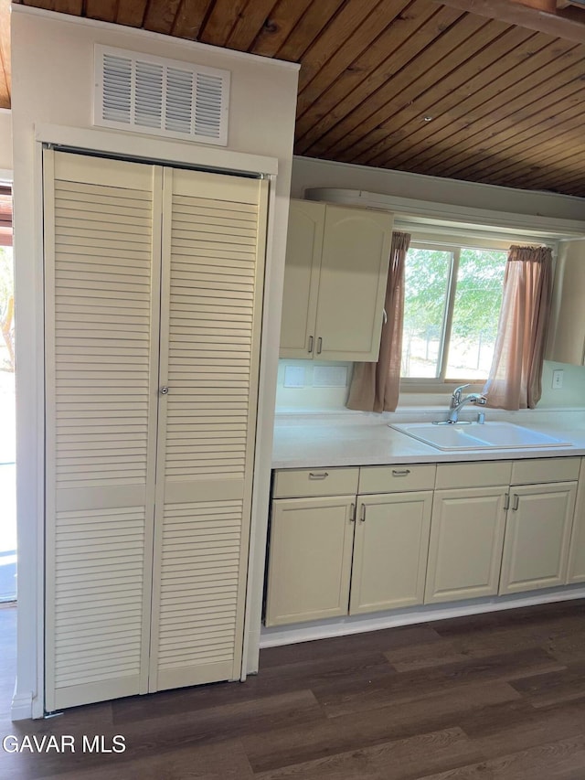 3358 Martin Ave, Mojave, CA 93501 - kitchen with wooden ceiling, light countertops, white cabinets, and dark wood-style floors